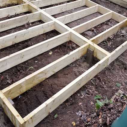 covering vegtable plot with base for workshop